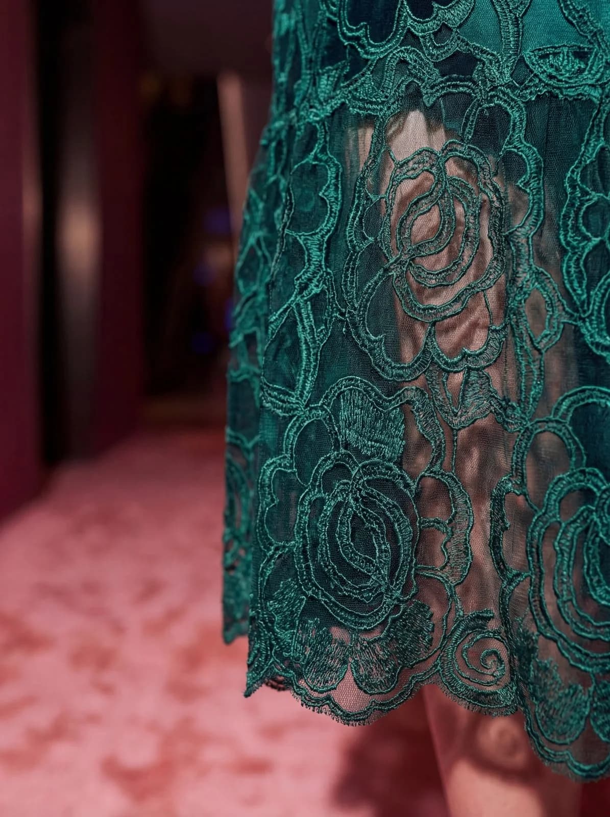 Cartolina: A close view of green lace fabric.