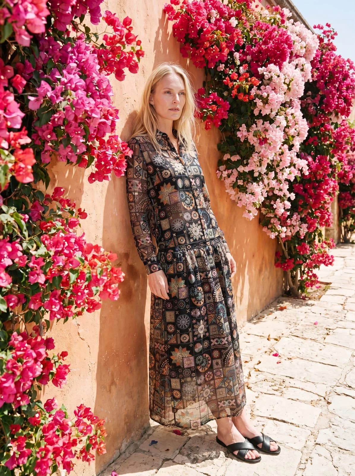 Cartolina: A printed dress against pink bougainvillea.