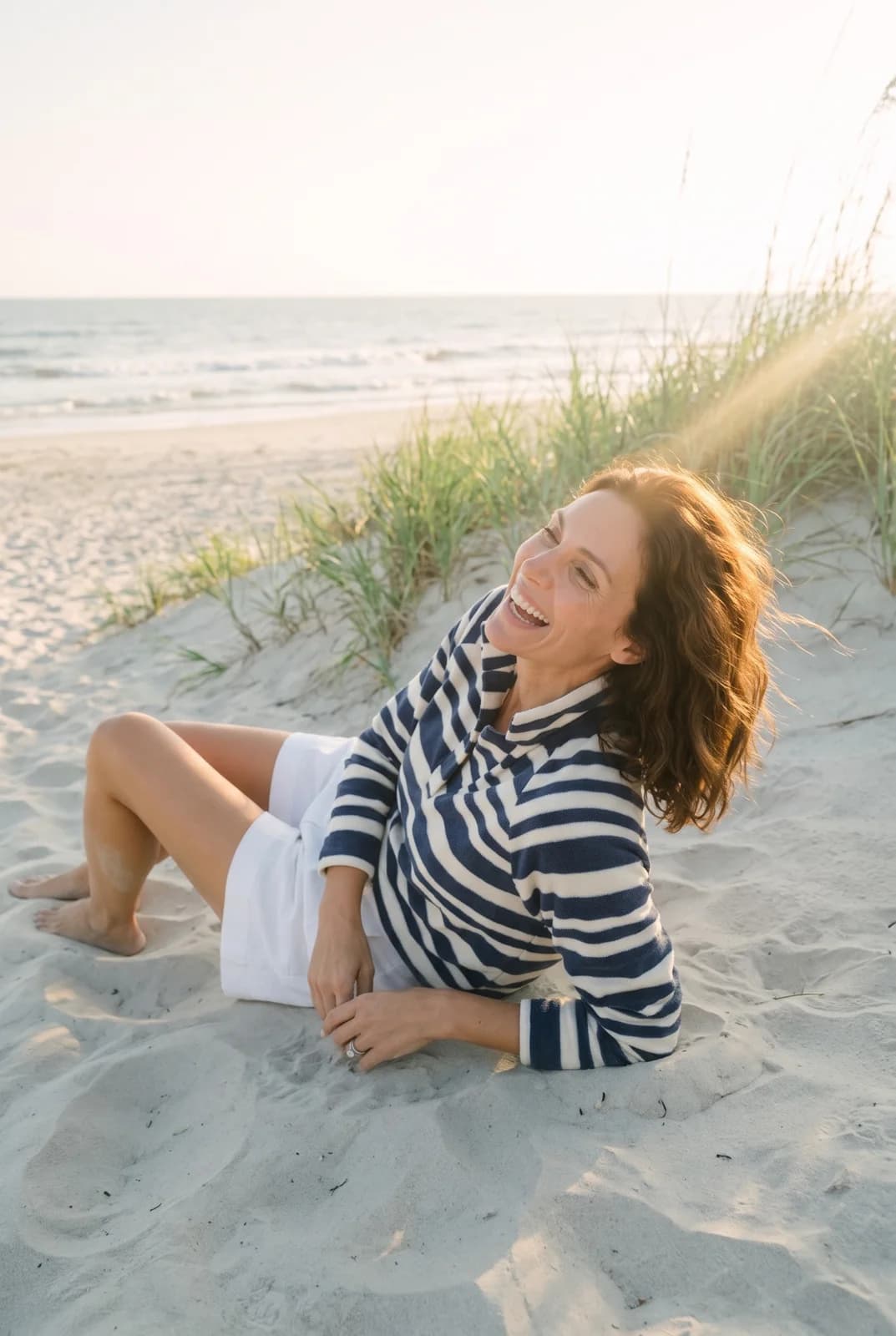 Dudley Stephens: A striped top on a beach at sunset.