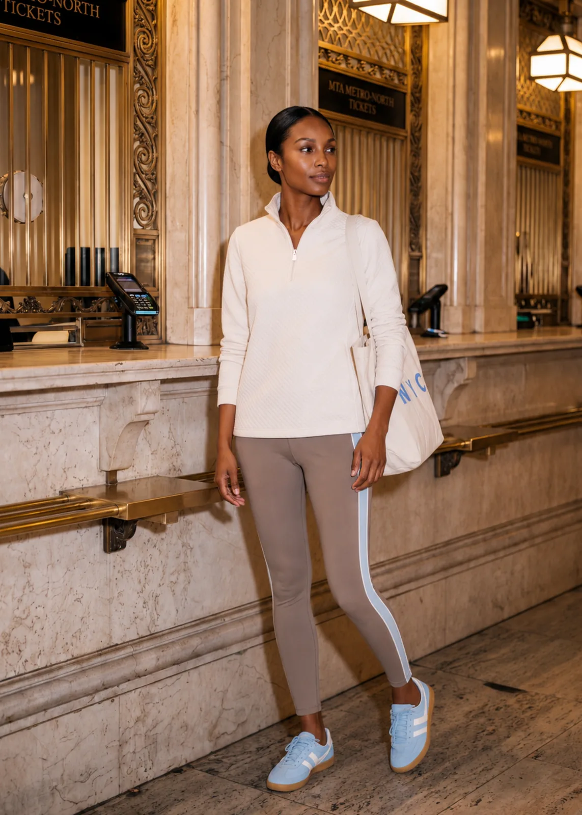 Pocomo Pullover campaign image with a model walking through a ticket hall.
