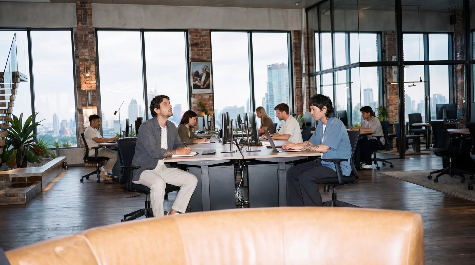 A team works around a table in the One Grand office visualization.