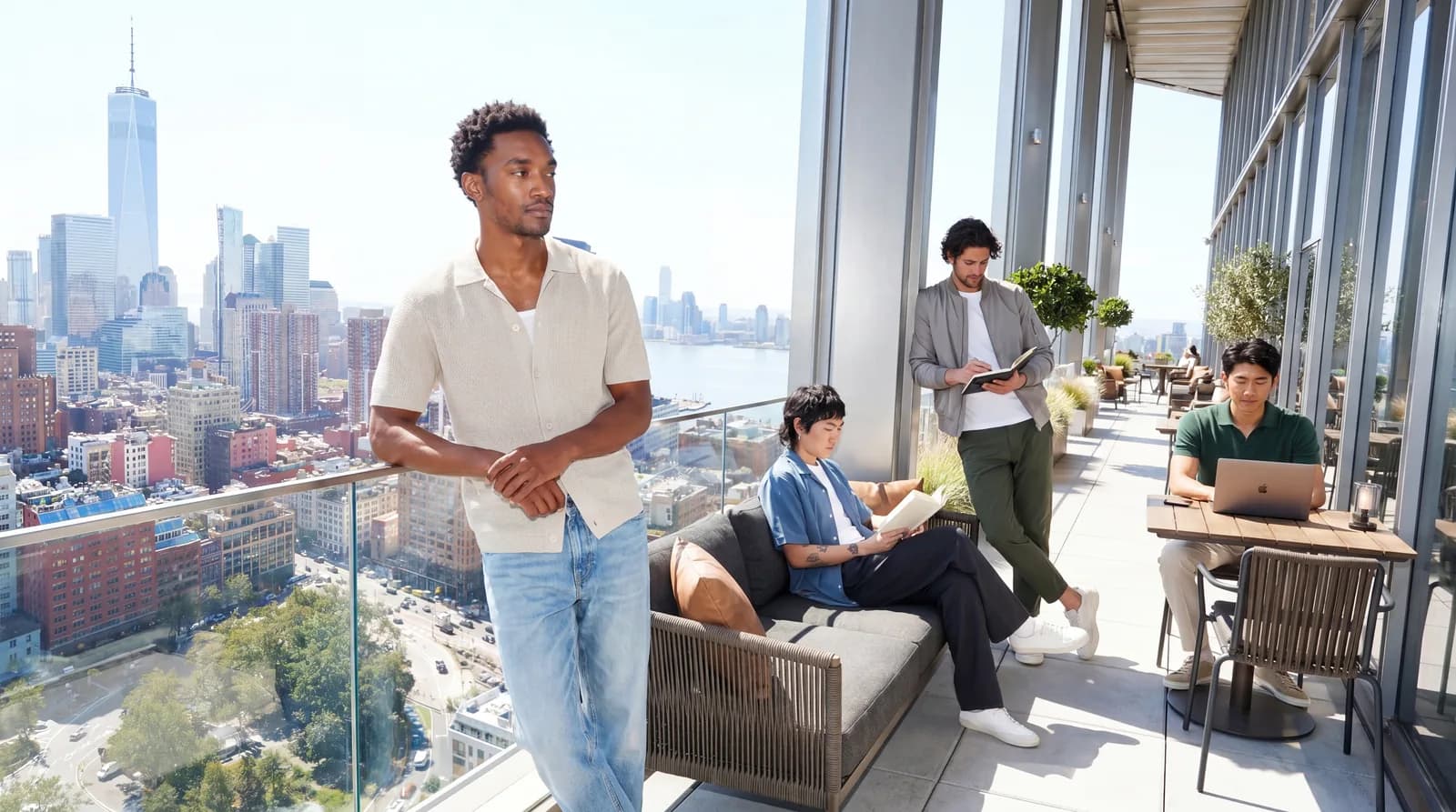 People use a sunlit lounge beside skyline windows.