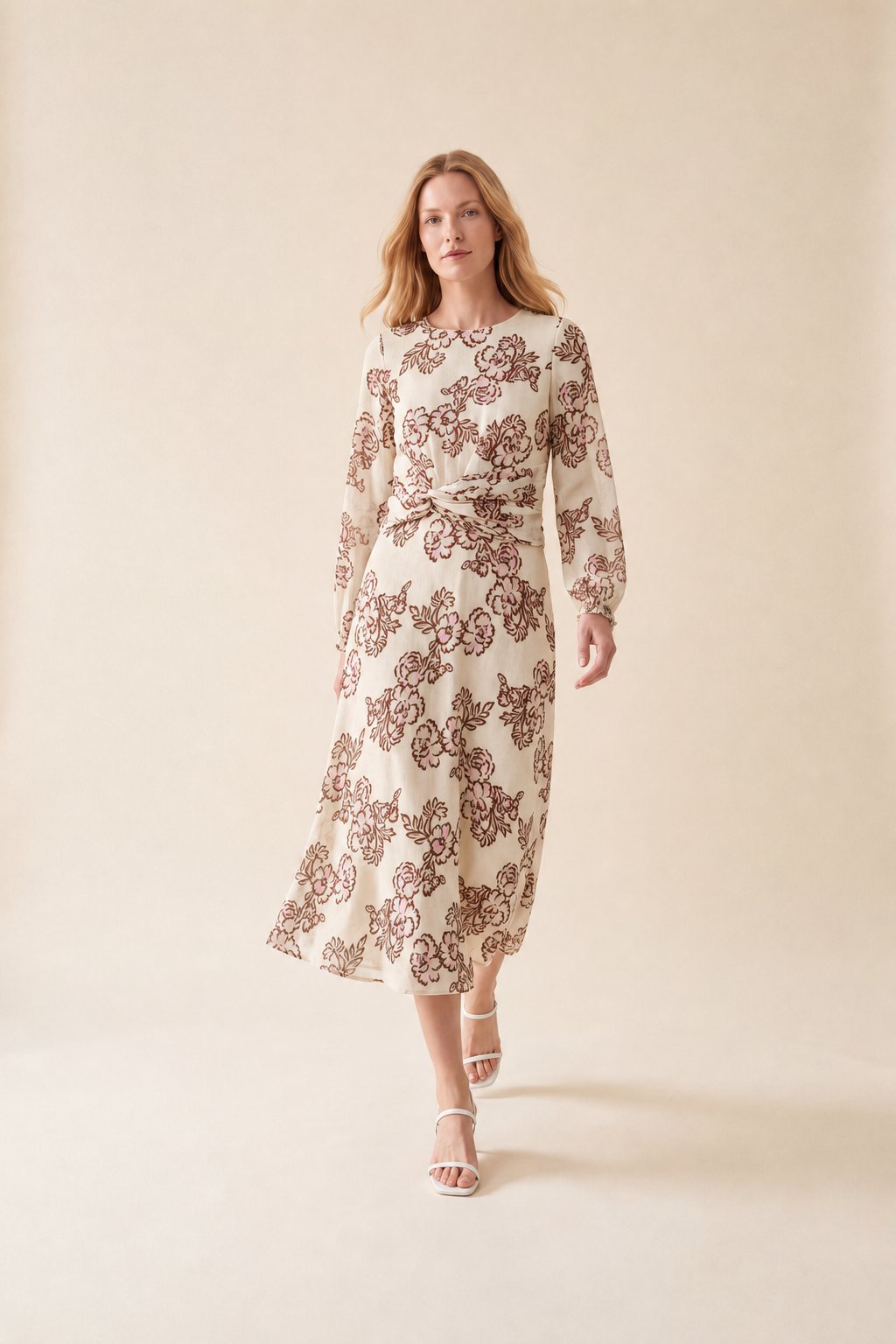 An AI model walks toward the camera in the Cartolina Sadie dress in the peony floral print, with long sleeves and a twisted front at the waist.