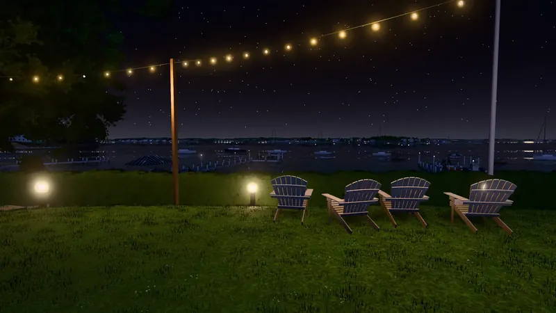 A lawn at night with Adirondack chairs under string lights, looking across dark water to a far shore.